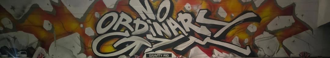 Graffiti wall inside the gym reading NO ORDINARY GYM, with a GRAVITY RIG sign beneath